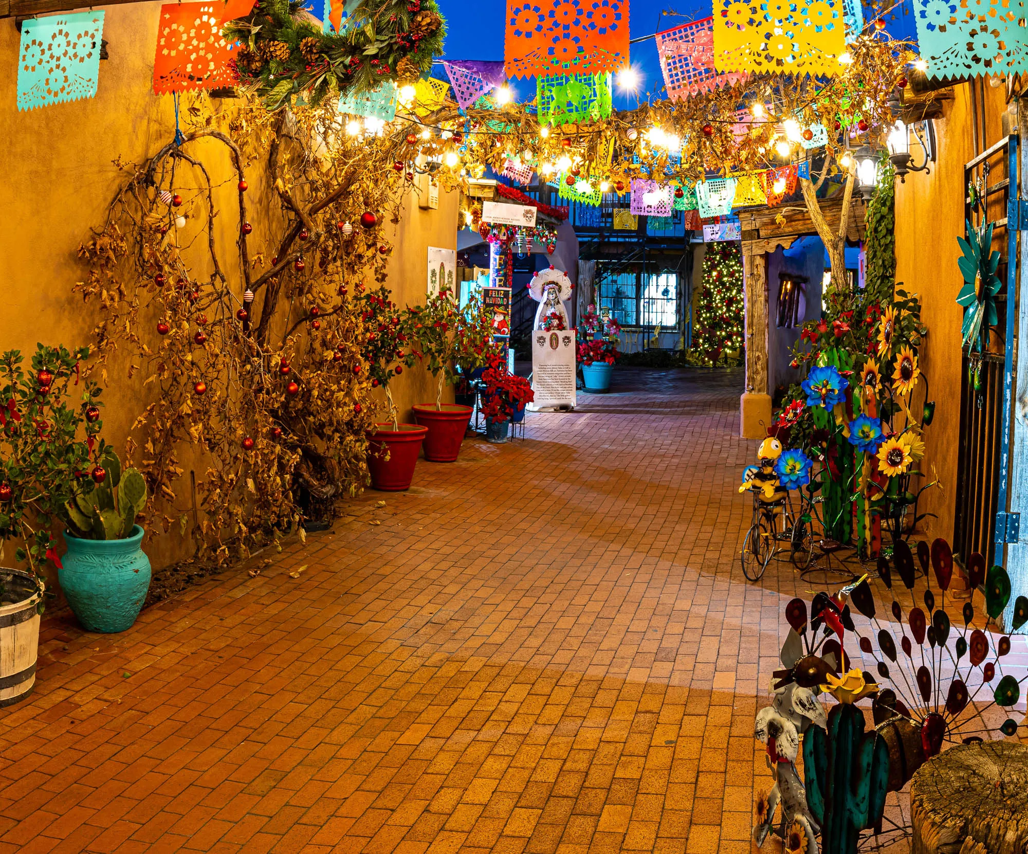 Courtyard lined with papel picado and flowers in Old Town Albuquerque