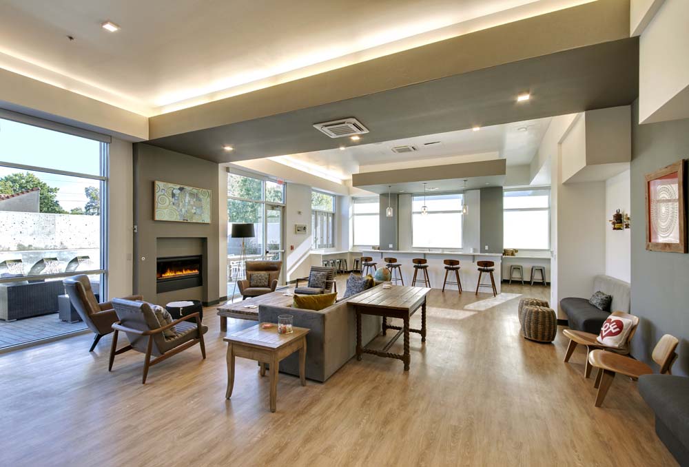 Residents' lounge with a fireplace, seating, and a coffee bar at The Franz