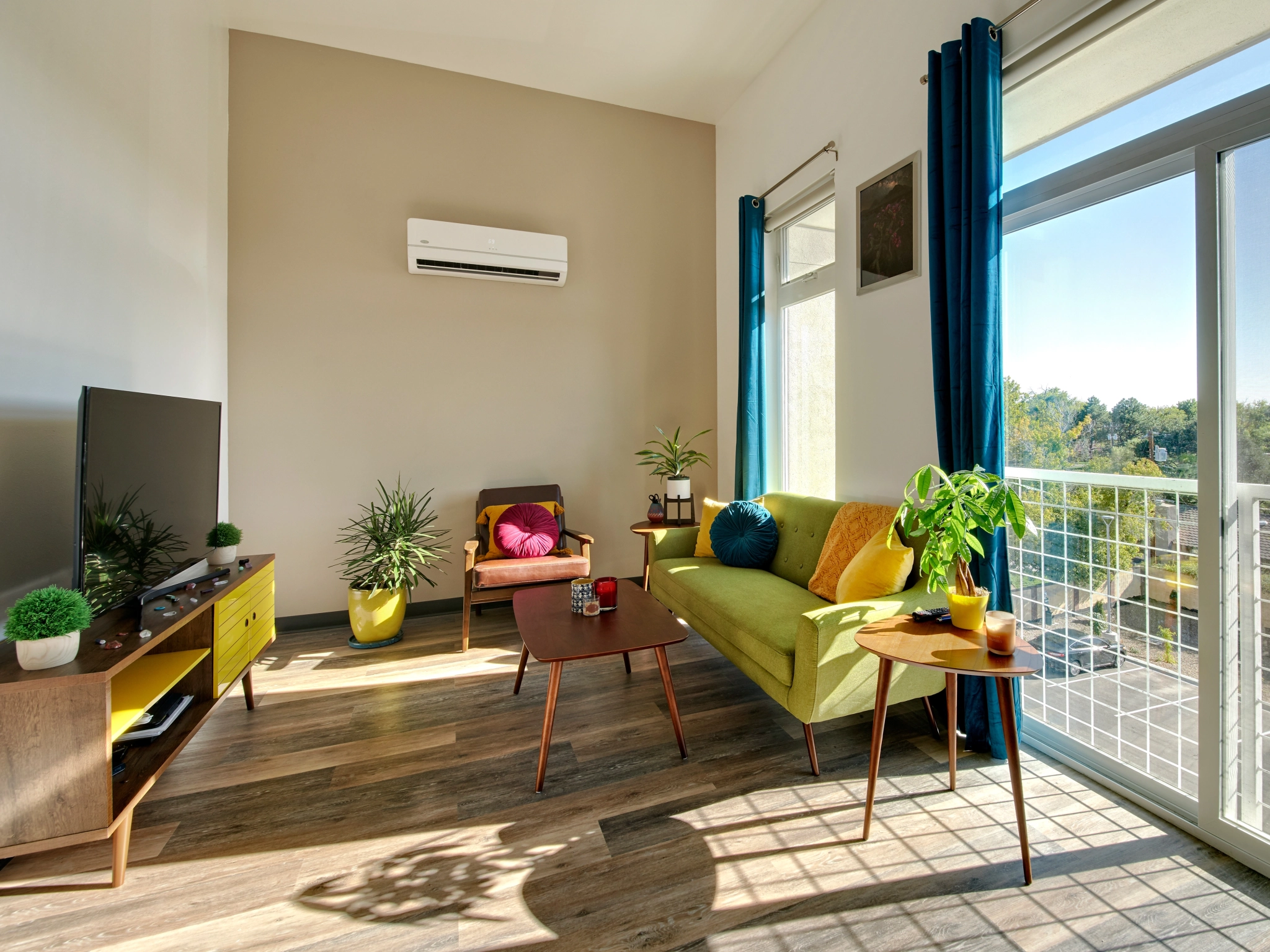Bright living room with a balcony and mountain views at The Franz