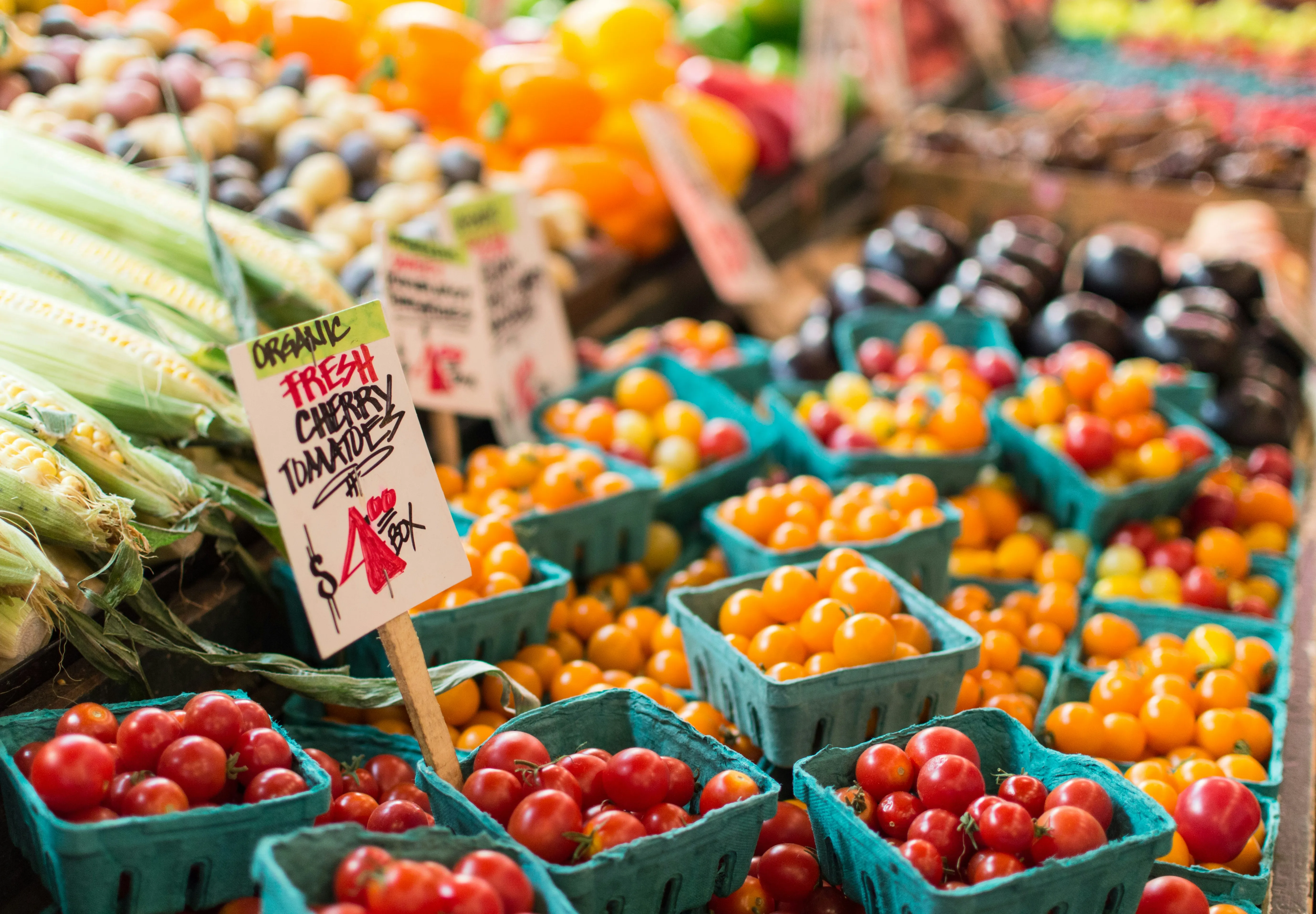 Heirloom tomatoes, peppers, and corn at a local farmers market