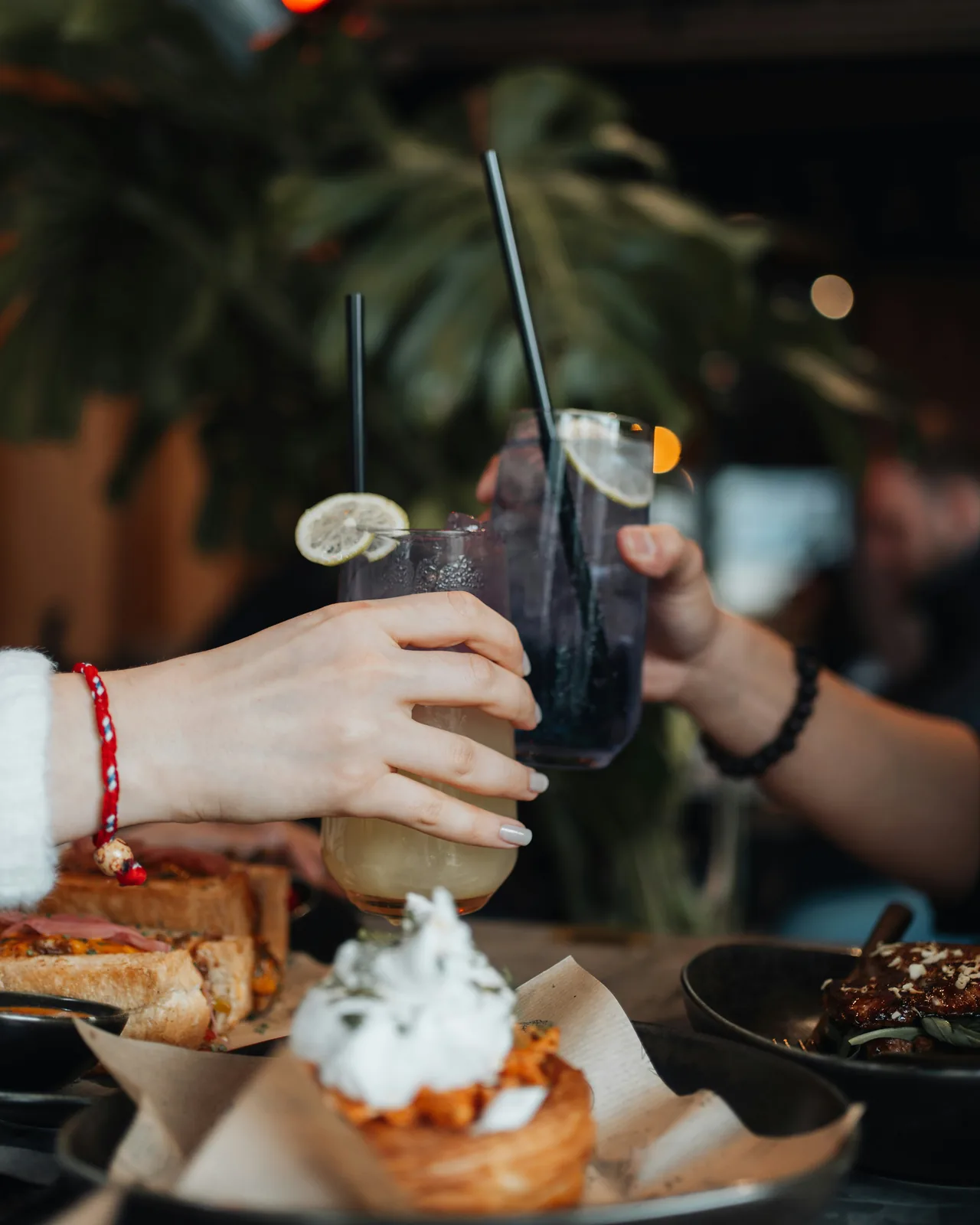 Friends toasting with drinks over dessert at a local restaurant